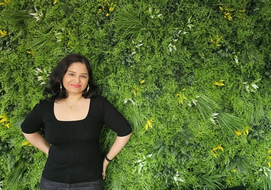 anagha deshpande in front of a green wall